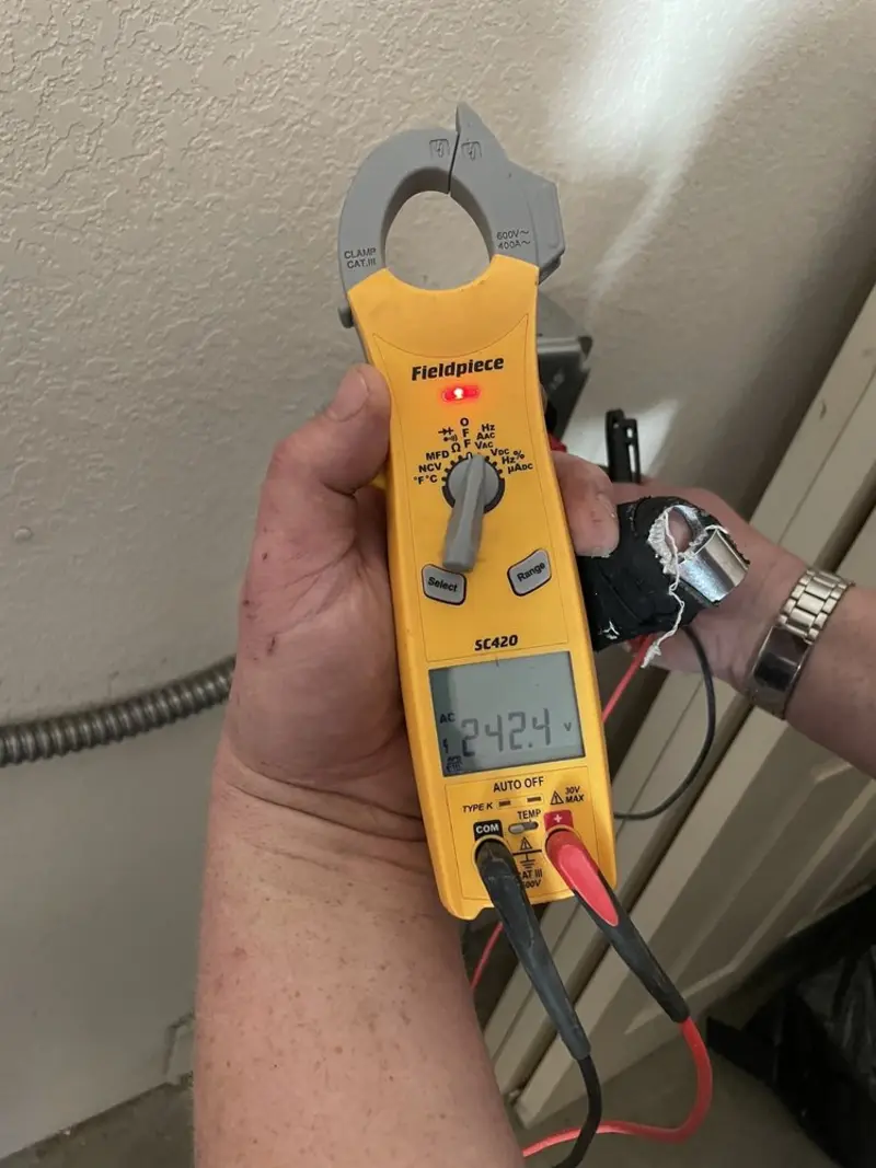 Voltage testing with clamp meter during Ceiling Fan Installation in Dallas